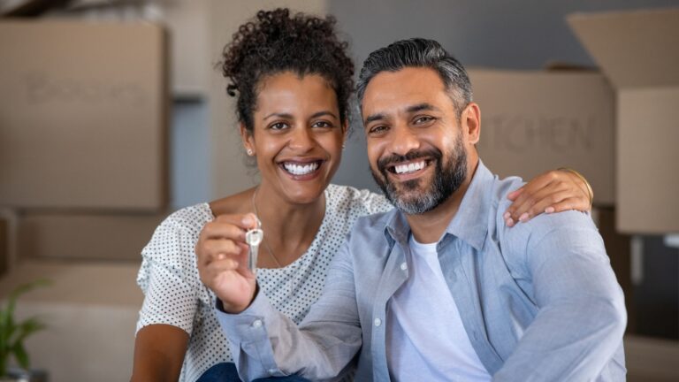 Couple holding up house keys